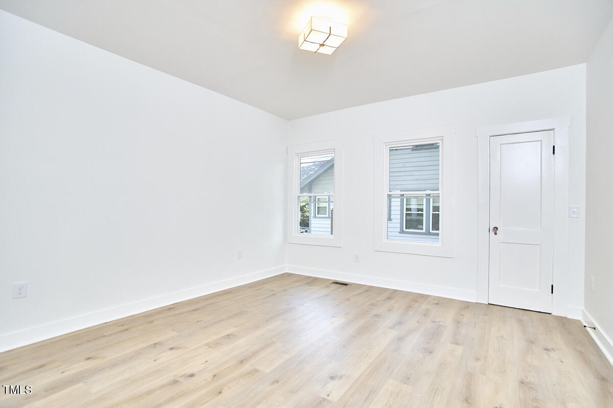 2203 University Drive Durham, NC 27707 - Photo 21 of 40 an empty room with wooden floor and windows