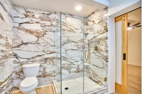 a white toilet sitting next to a shower curtain