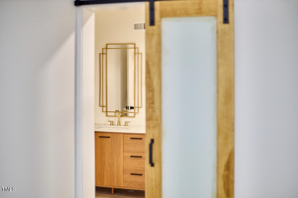 2203 University Drive Durham, NC 27707 - Photo 27 of 40 a bathroom with a sink and a mirror