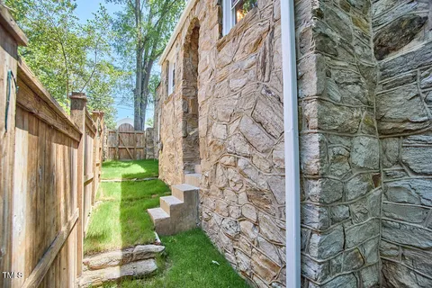 a view of a pathway of a house with a yard