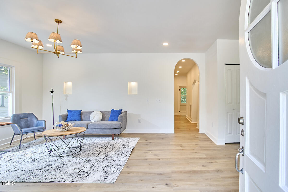 2203 University Drive Durham, NC 27707 - Photo 3 of 40 a living room with furniture and a chandelier