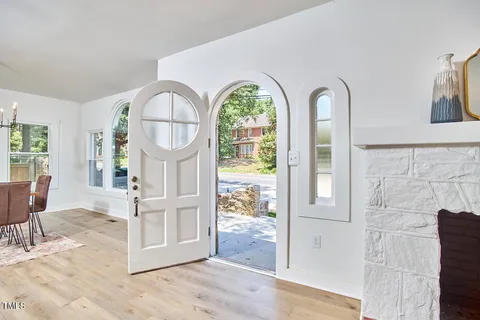 a view of a livingroom with wooden floor and a dining space with wooden floor