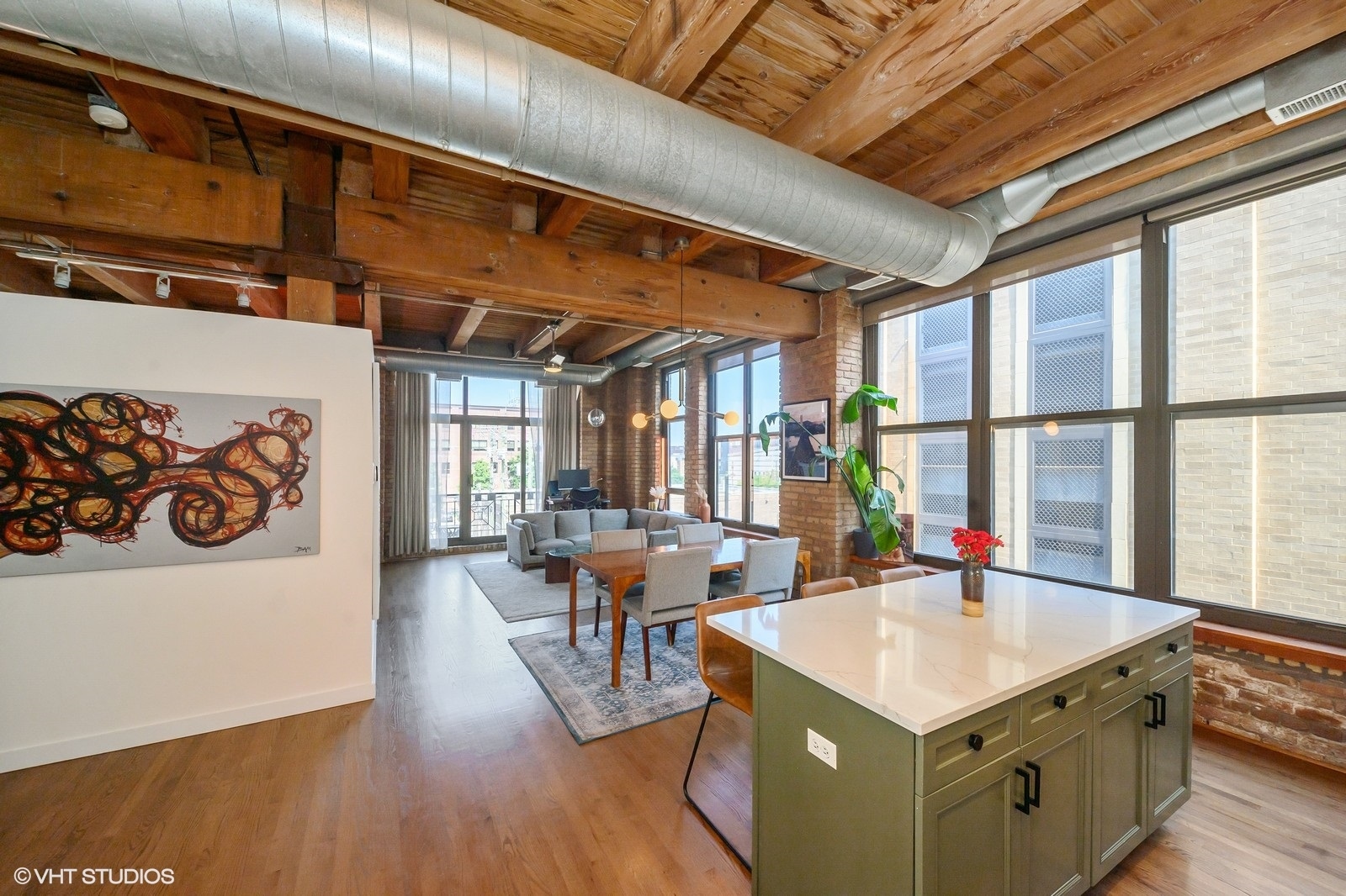 1330 West Monroe Street, Unit 311 Chicago, IL 60607 - Photo 7 of 16 a view of kitchen island with furniture and wooden floor