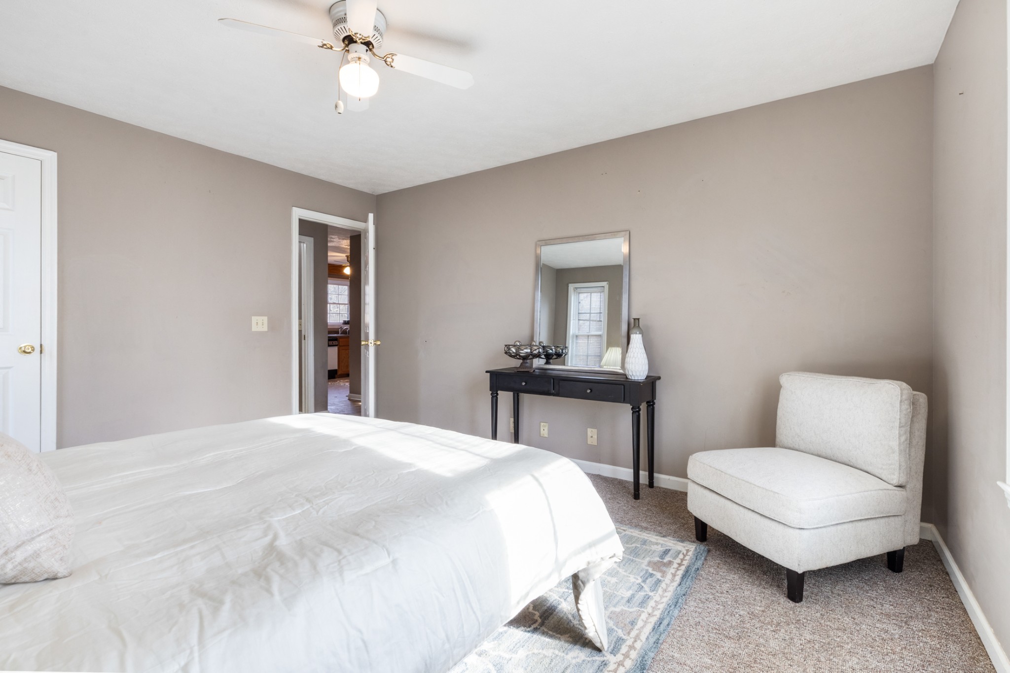 251 Rouse Road Dickson, TN 37055 - Photo 17 of 46 a bedroom with a bed a chandelier and a dresser
