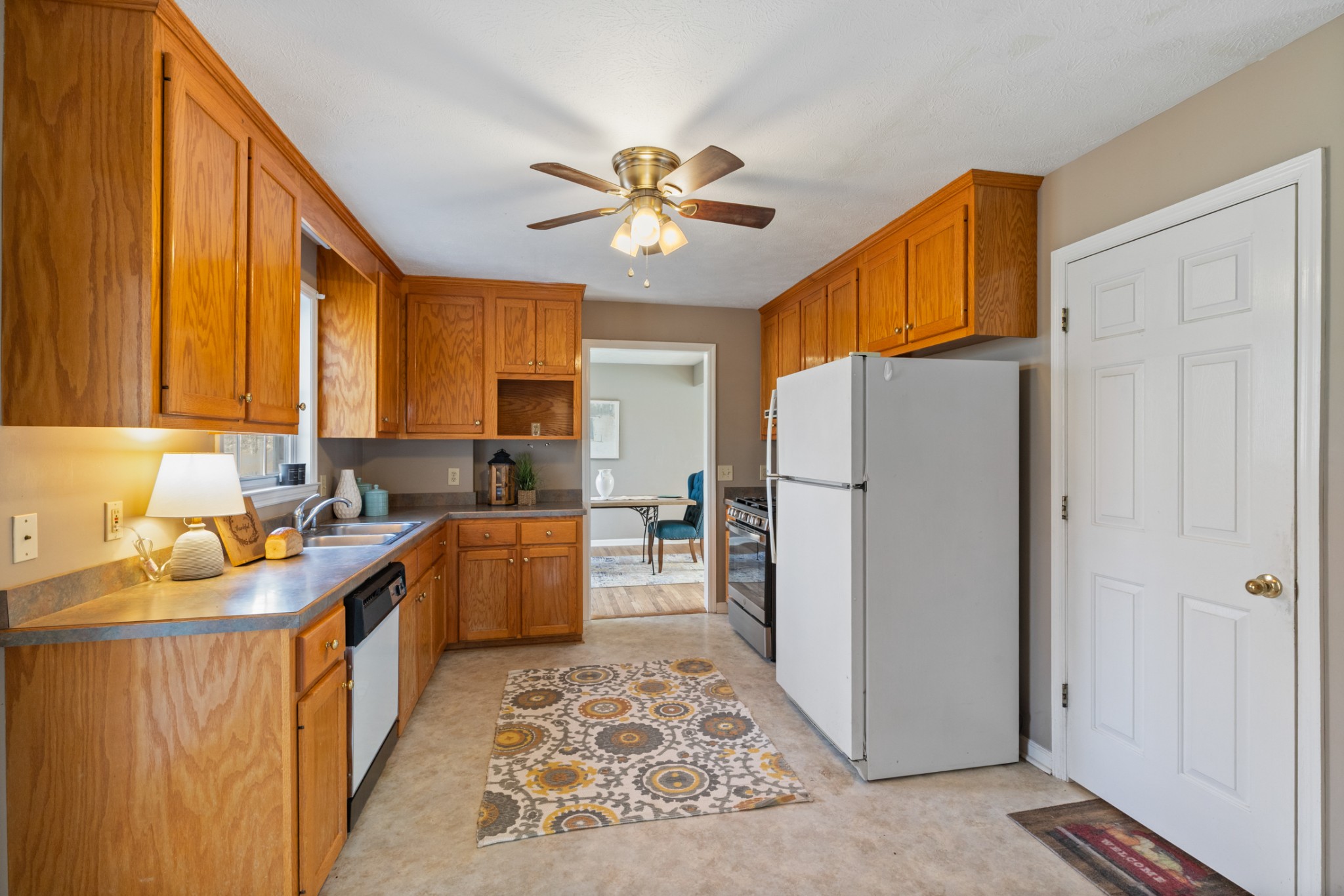 251 Rouse Road Dickson, TN 37055 - Photo 7 of 46 a kitchen with a refrigerator a sink and dishwasher with a dining table