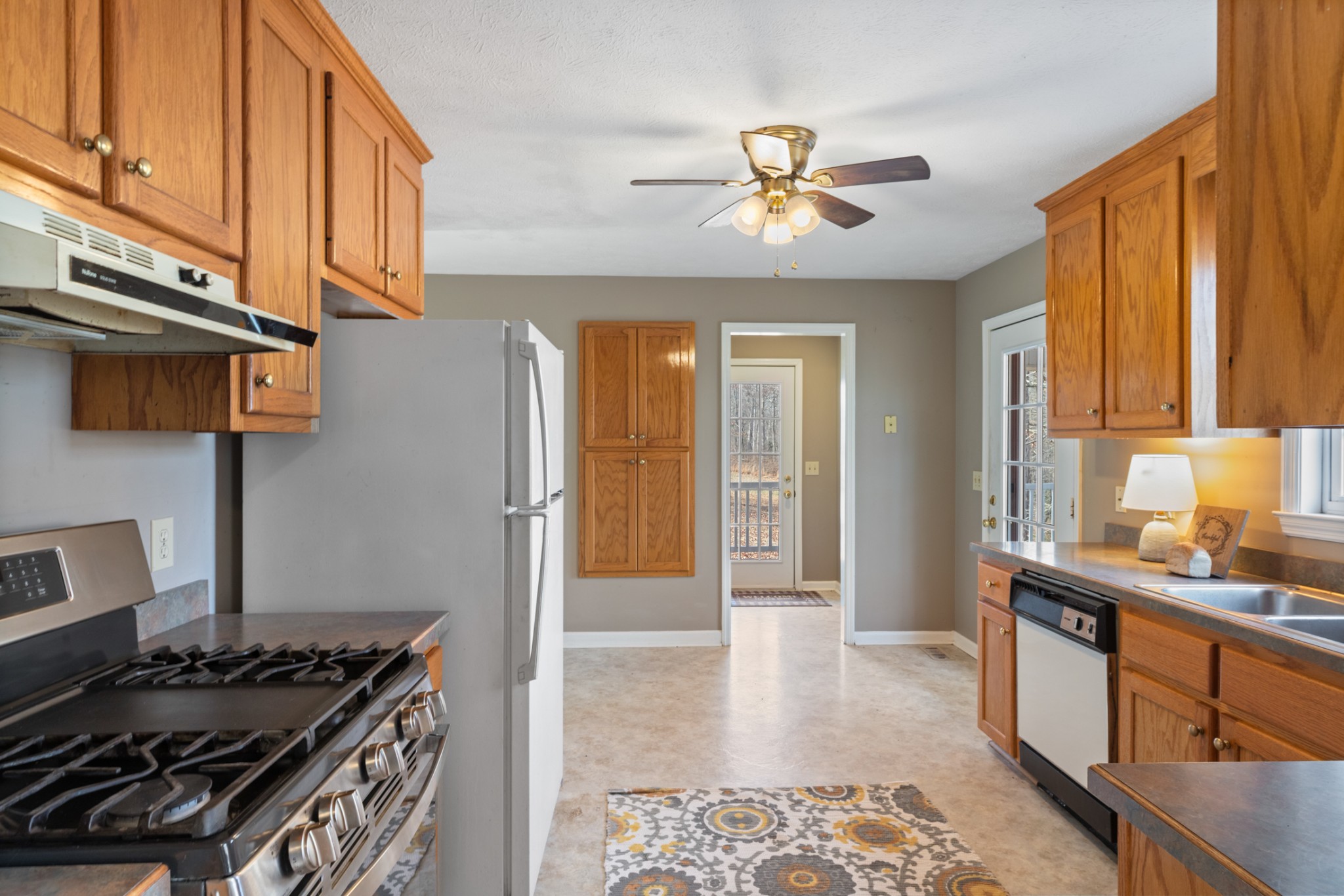 251 Rouse Road Dickson, TN 37055 - Photo 9 of 46 a kitchen with stainless steel appliances granite countertop a stove a sink and a refrigerator