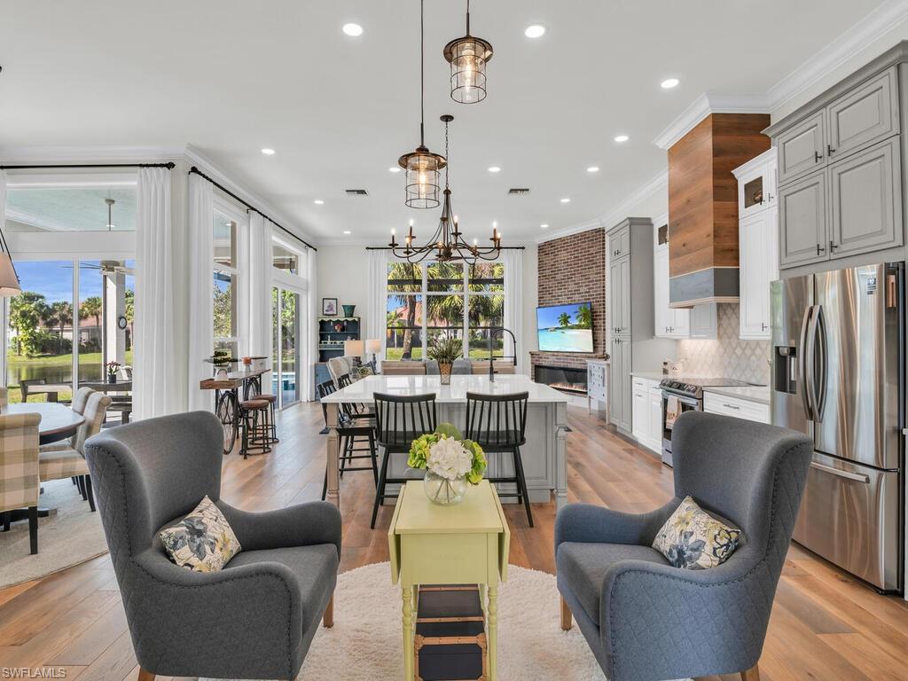 8541 Peppertree Way Naples, FL 34114 - Photo 1 of 36 Open concept living with spectacular kitchen, harwoods, fireplace and so much more! Windows and natural light galore.