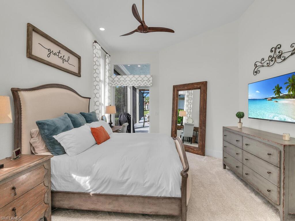 8541 Peppertree Way Naples, FL 34114 - Photo 11 of 36 Primary bedroom with volume ceiling and sliders to lanai