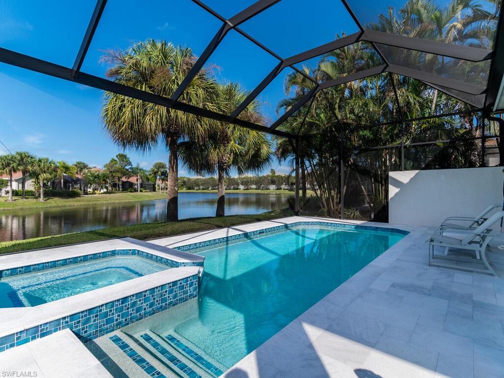 8541 Peppertree Way Naples, FL 34114 - Photo 18 of 36 View of pool and long lake and newly designed outdoor space. Travertine decking, re-surfaced/re-tiled pool, picture framed screen lanai