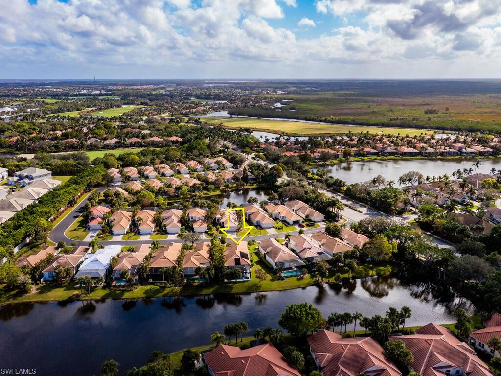 8541 Peppertree Way Naples, FL 34114 - Photo 25 of 36 Aerial view showing lake behind house