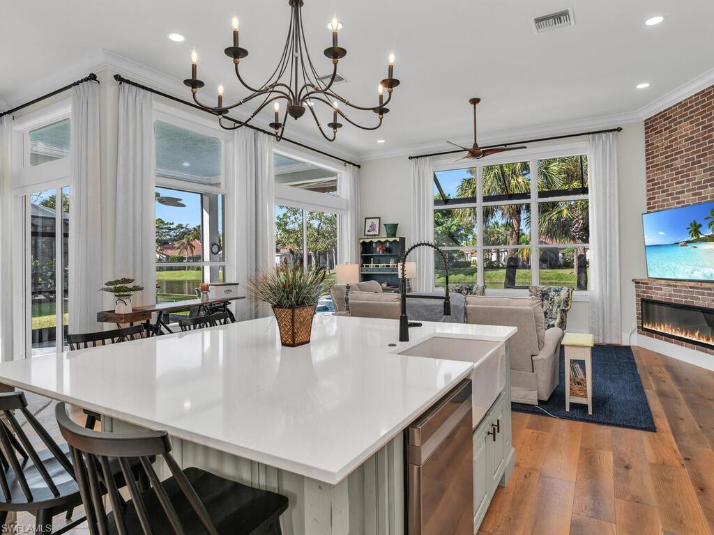 8541 Peppertree Way Naples, FL 34114 - Photo 6 of 36 Kitchen featuring a huge center island with sink, chandelier, with loads of natural light and views
