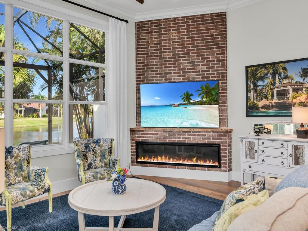 8541 Peppertree Way Naples, FL 34114 - Photo 8 of 36 Electric fireplace, brick feature wall