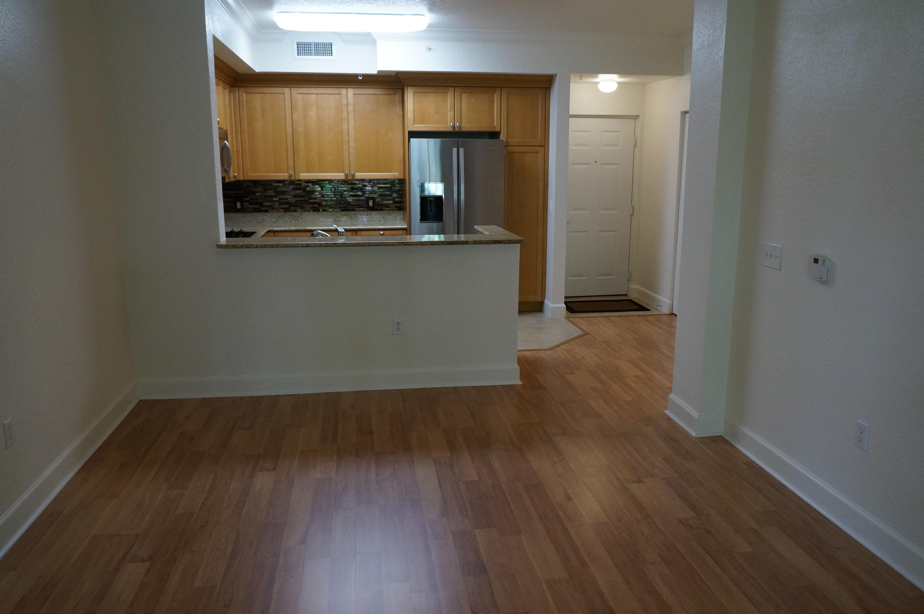1121 Renaissance Way, Unit 121 Boynton Beach, FL 33426 - Photo 18 of 28 an empty room with wooden floor and a window