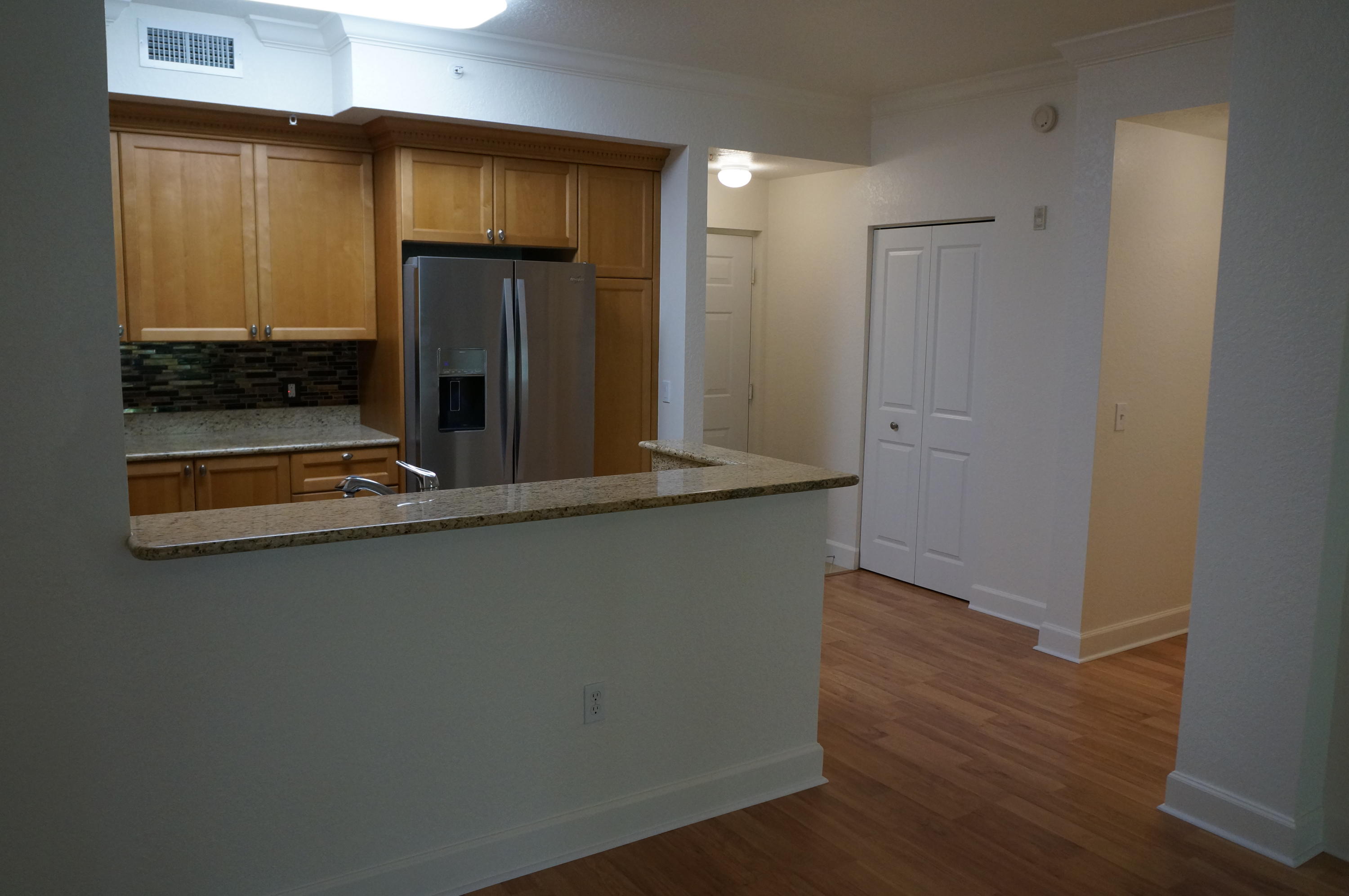 1121 Renaissance Way, Unit 121 Boynton Beach, FL 33426 - Photo 5 of 28 a kitchen with stainless steel appliances granite countertop a refrigerator and a stove