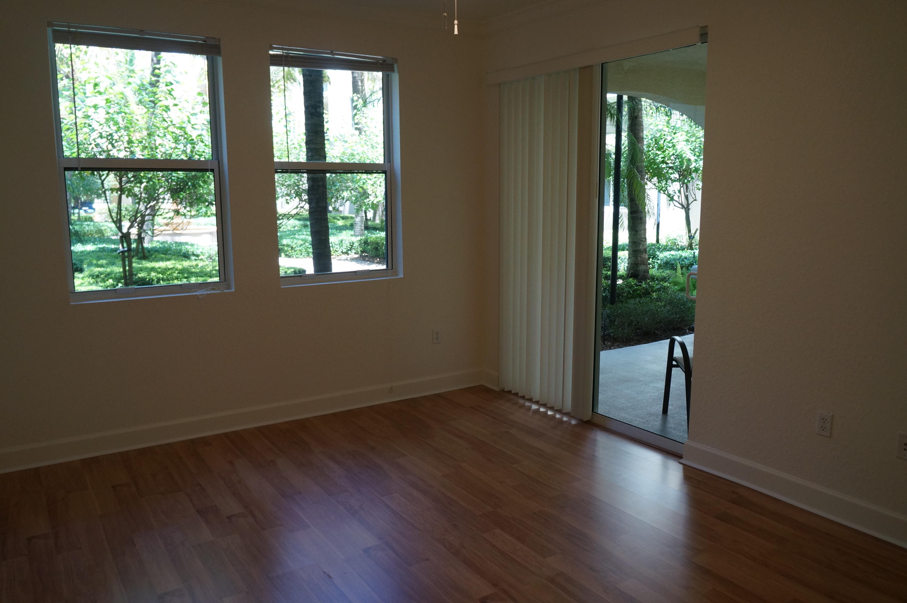 1121 Renaissance Way, Unit 121 Boynton Beach, FL 33426 - Photo 6 of 28 an empty room with wooden floor and windows