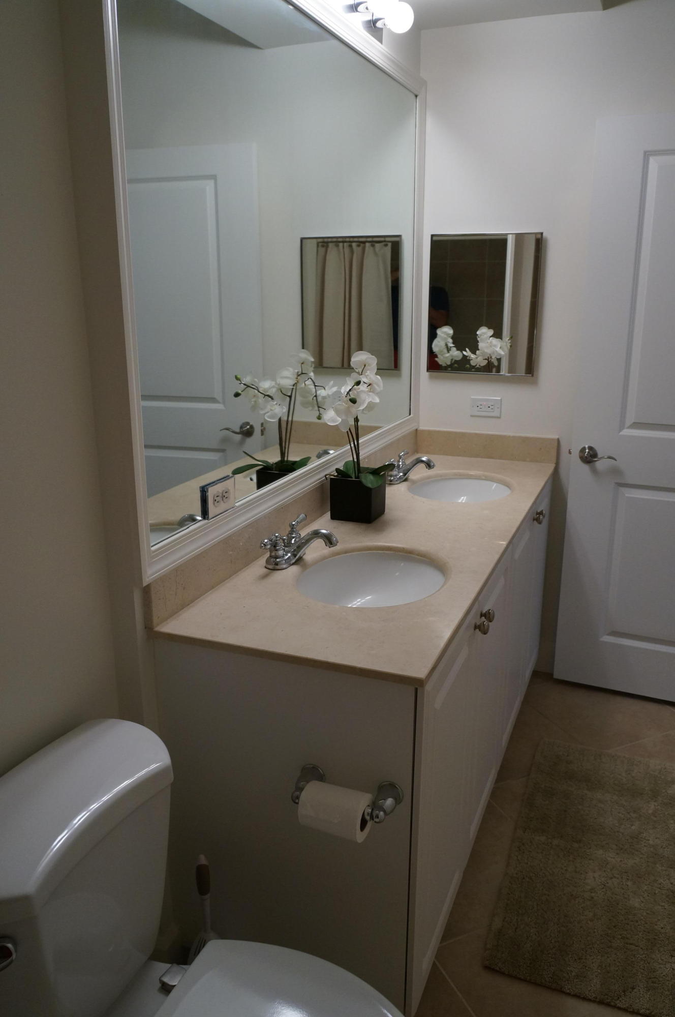 1121 Renaissance Way, Unit 121 Boynton Beach, FL 33426 - Photo 9 of 28 a bathroom with a toilet sink and mirror