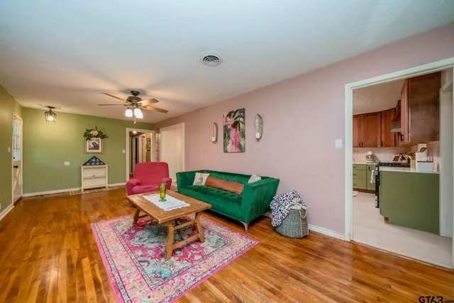 a living room with furniture and wooden floor