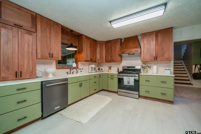 a kitchen with cabinets a sink and a stove