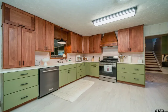 a kitchen with cabinets a sink and a stove