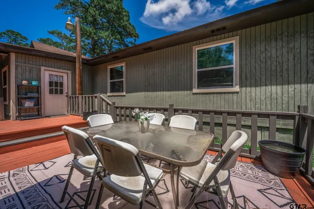 a backyard of a house with table and chairs