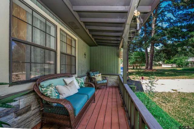 a sitting area with furniture and wooden deck