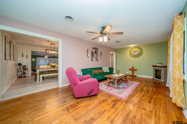 a living room with furniture and a wooden floor