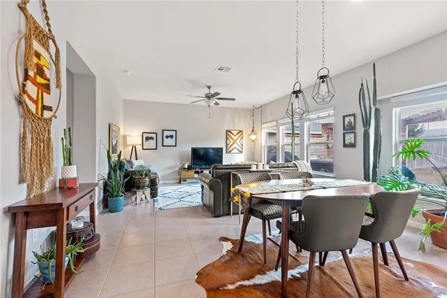 a view of a dining room with furniture and a potted plant