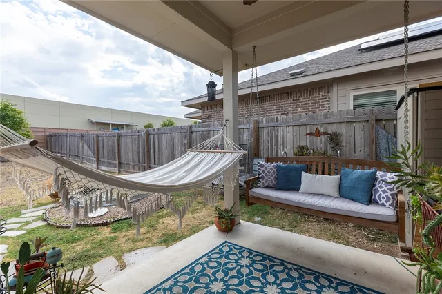 a view of a patio with couches chairs and wooden floor
