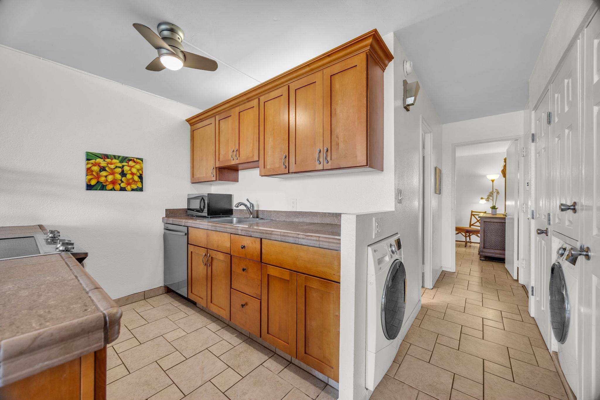 2191 South Kihei Road, Unit 2306 Kihei, HI 96753 - Photo 13 of 41 a kitchen with a refrigerator and a sink