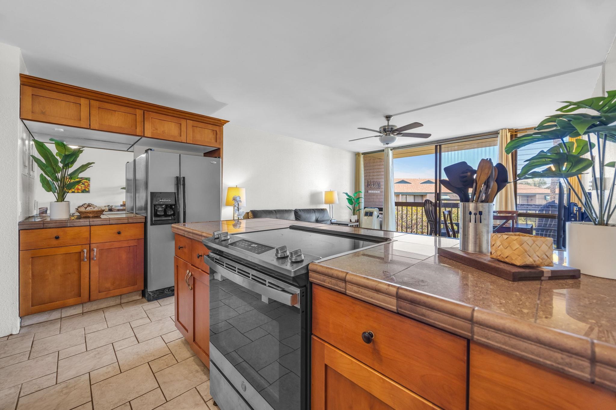 2191 South Kihei Road, Unit 2306 Kihei, HI 96753 - Photo 15 of 41 a kitchen with stainless steel appliances granite countertop a sink stove and cabinets
