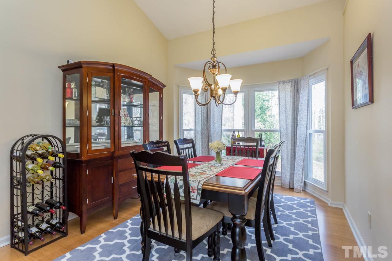 4305 Birmingham Way Raleigh, NC 27604 - Photo 11 of 23 a view of a dining room with furniture and chandelier