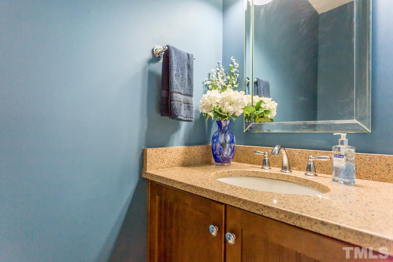 4305 Birmingham Way Raleigh, NC 27604 - Photo 13 of 23 a bathroom with a sink a vanity and a mirror