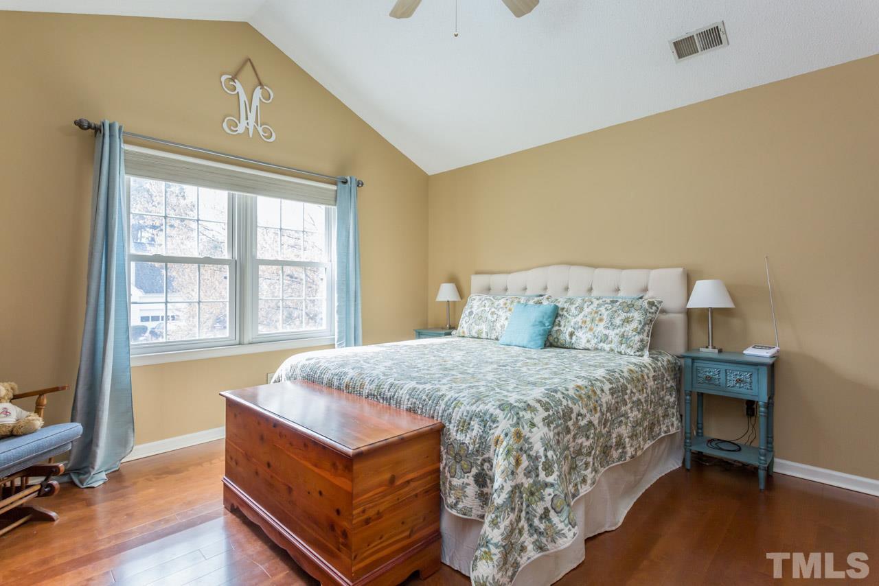 4305 Birmingham Way Raleigh, NC 27604 - Photo 15 of 23 a bed sitting in a bedroom next to a window