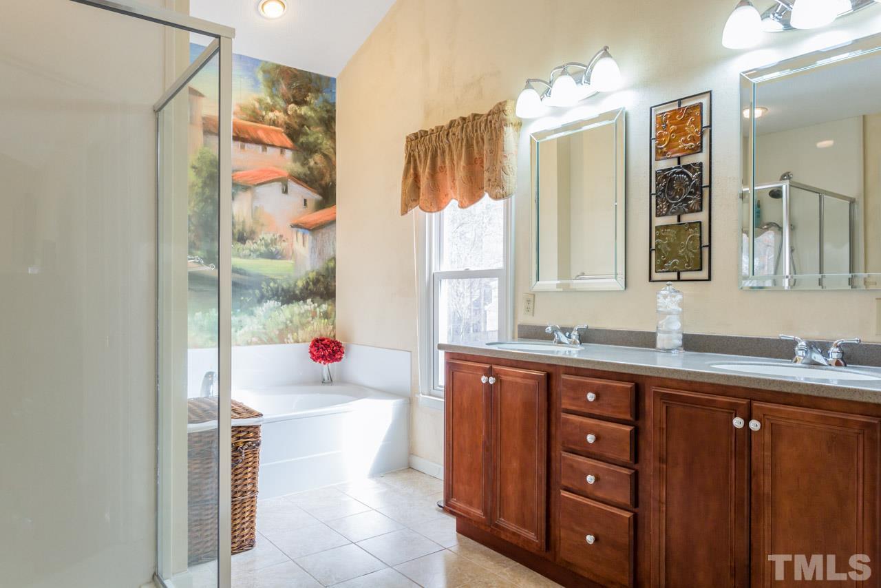 4305 Birmingham Way Raleigh, NC 27604 - Photo 16 of 23 a bathroom with a sink vanity mirror and shower
