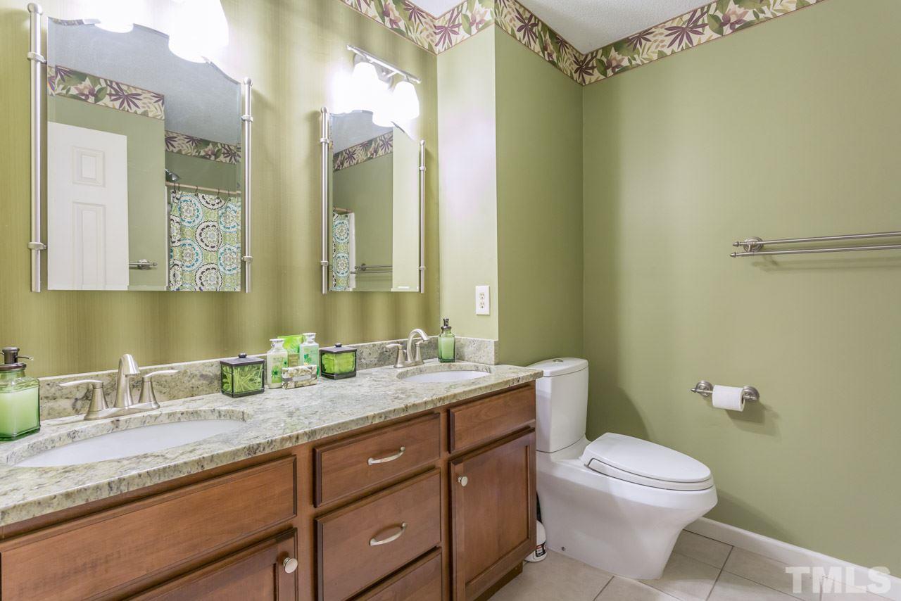 4305 Birmingham Way Raleigh, NC 27604 - Photo 19 of 23 a bathroom with a granite countertop sink toilet and shower