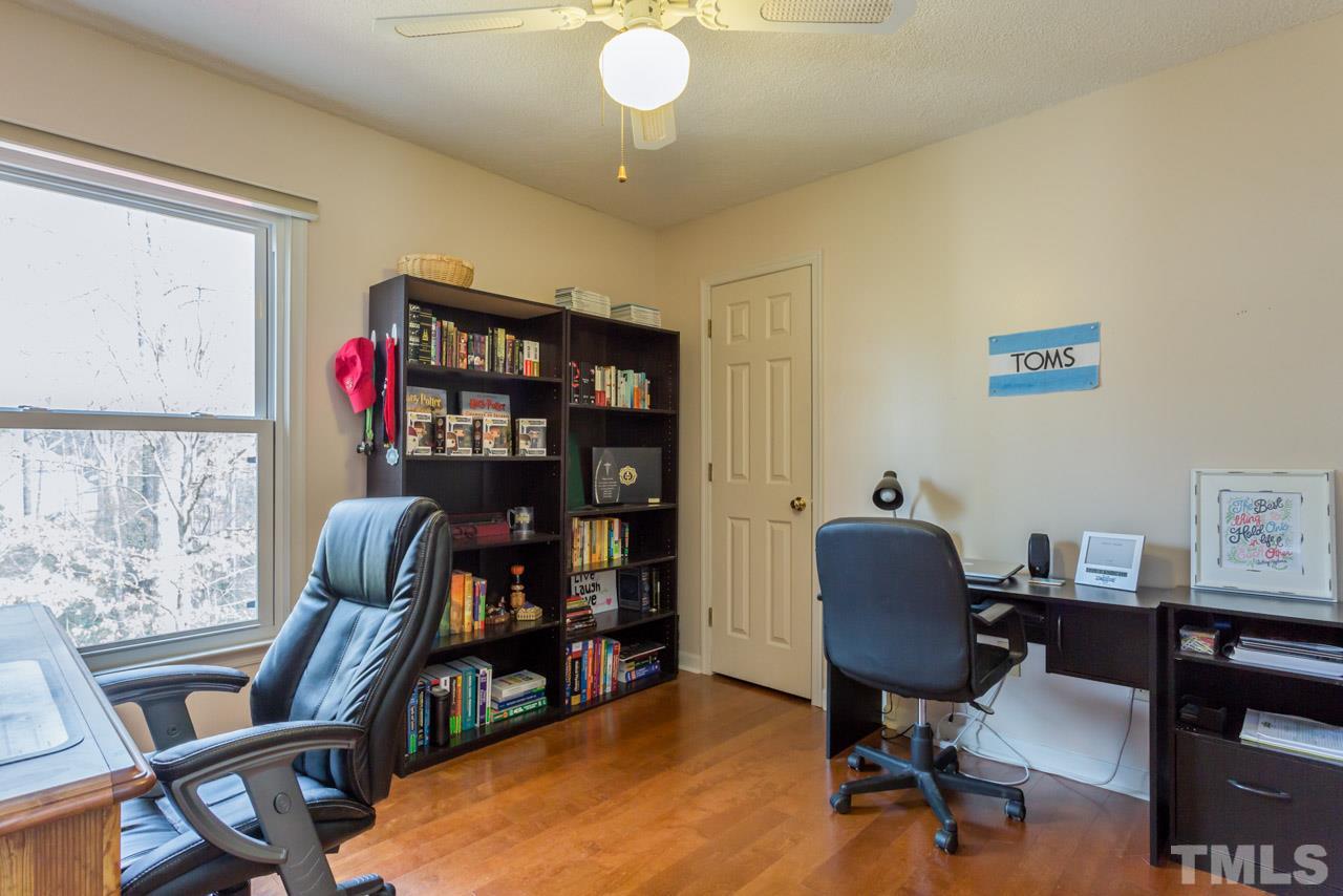 4305 Birmingham Way Raleigh, NC 27604 - Photo 20 of 23 a view of a workspace with furniture and a bookshelf