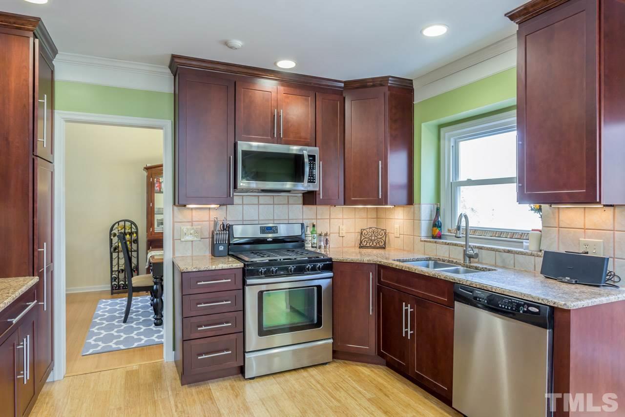 4305 Birmingham Way Raleigh, NC 27604 - Photo 3 of 23 a kitchen with stainless steel appliances granite countertop a stove a sink and a microwave