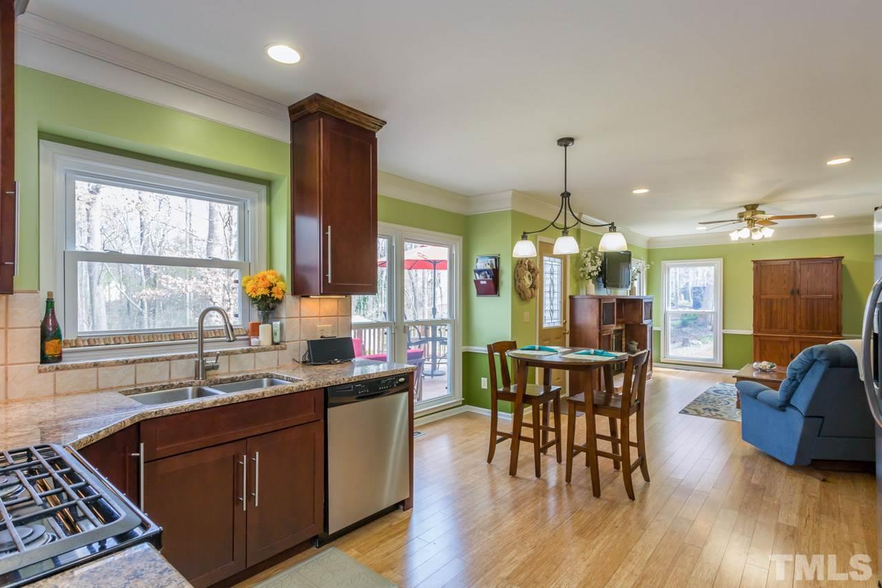 4305 Birmingham Way Raleigh, NC 27604 - Photo 5 of 23 a kitchen with stainless steel appliances granite countertop wooden floors and stove
