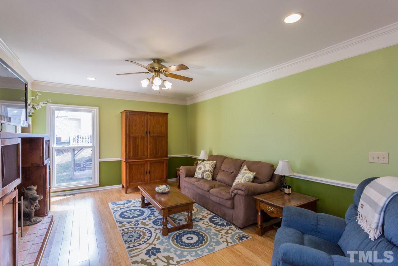 4305 Birmingham Way Raleigh, NC 27604 - Photo 7 of 23 a living room with furniture a flat screen tv and a table