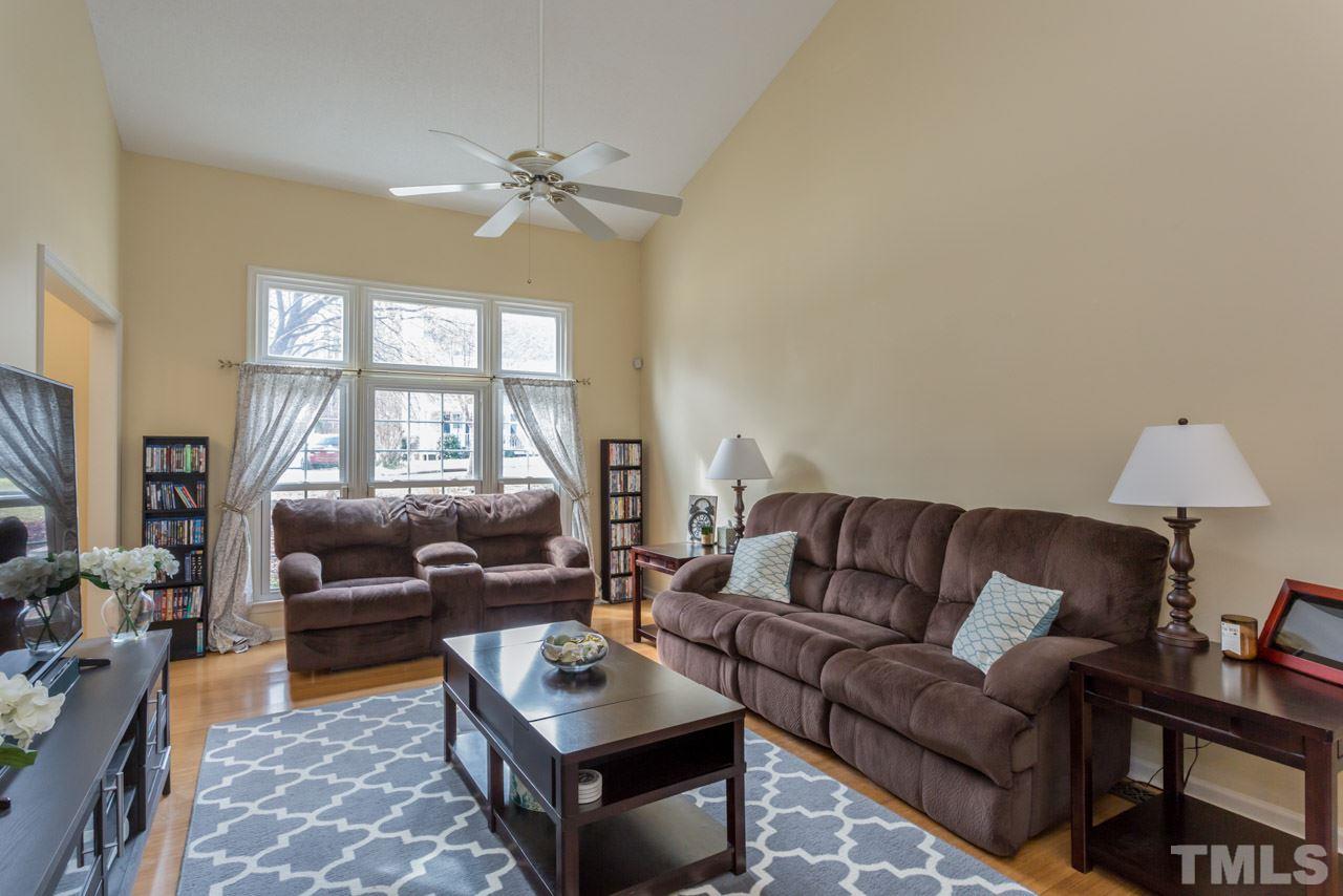 4305 Birmingham Way Raleigh, NC 27604 - Photo 10 of 23 a living room with furniture and a chandelier