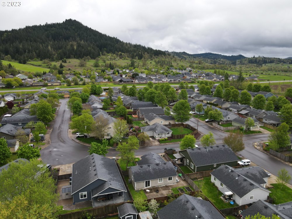 1832 South 57th Place Springfield, OR 97478 - Photo 3 of 29 an aerial view of green landscape with trees houses and mountain view