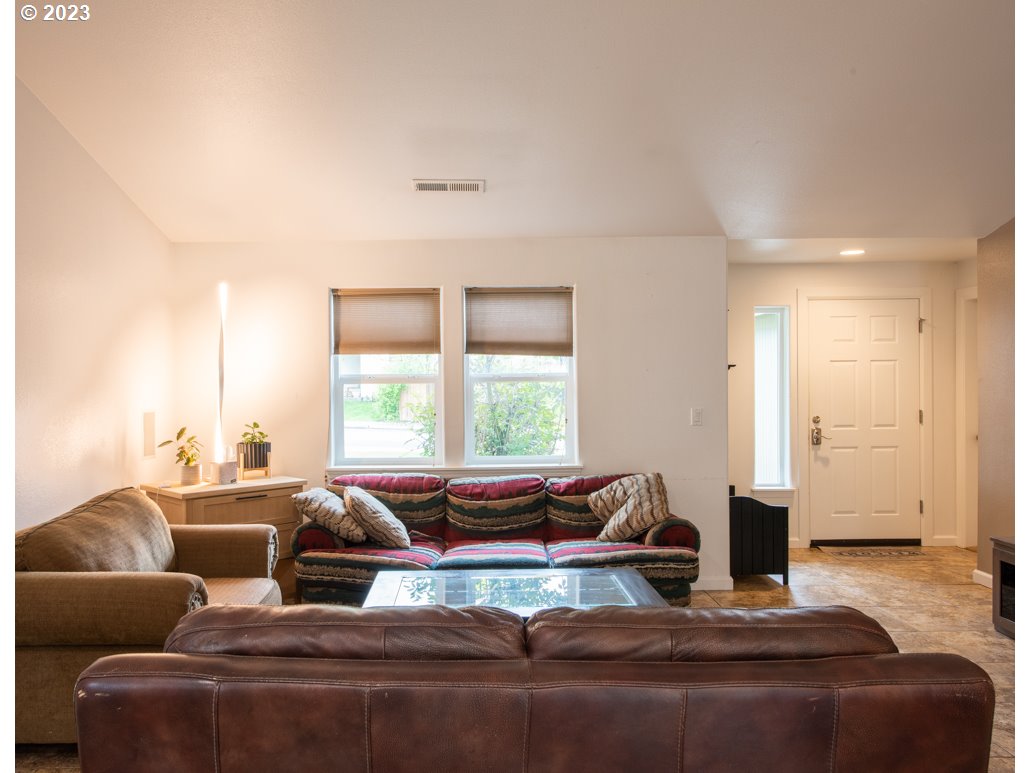 1832 South 57th Place Springfield, OR 97478 - Photo 8 of 29 a living room with furniture wooden floor and a large window