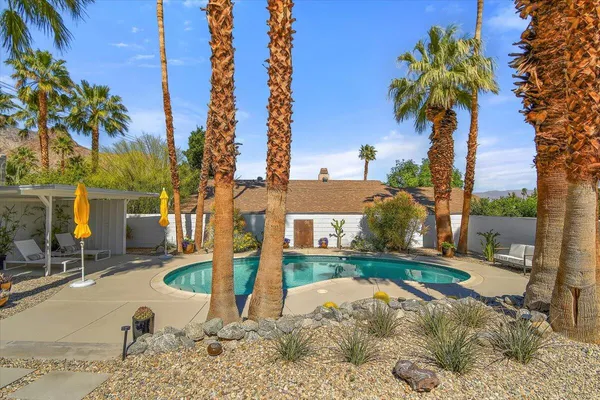 a swimming pool with outdoor seating and yard