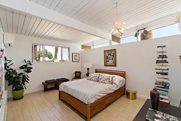 a bedroom with bed and window