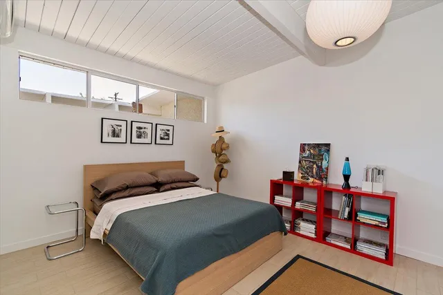 a bedroom with a bed a table and chair