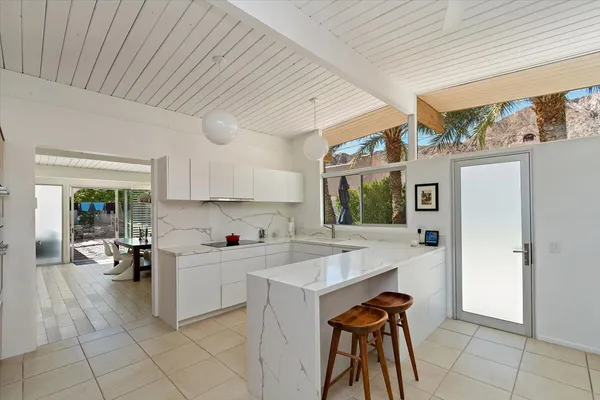 a kitchen with a sink cabinets and window
