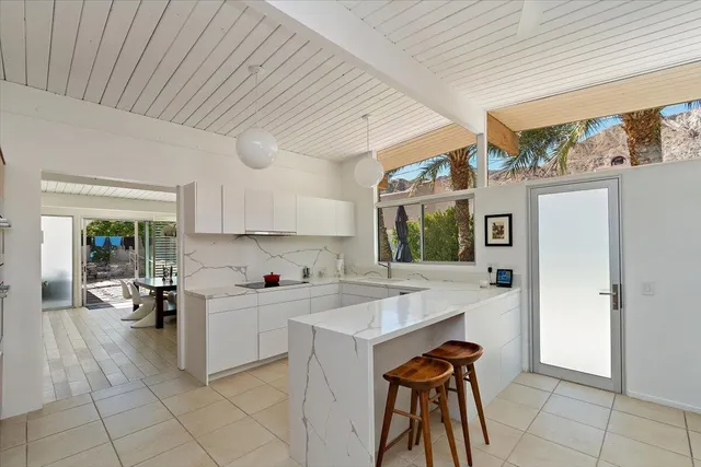 a kitchen with a sink cabinets and window