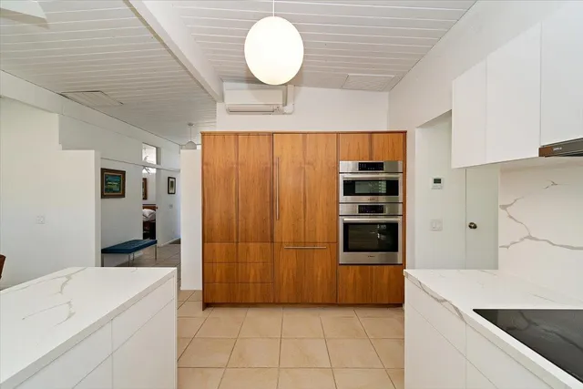 a kitchen with stainless steel appliances a refrigerator and a stove top oven