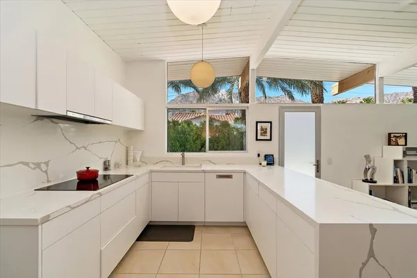 a kitchen with a sink cabinets and window