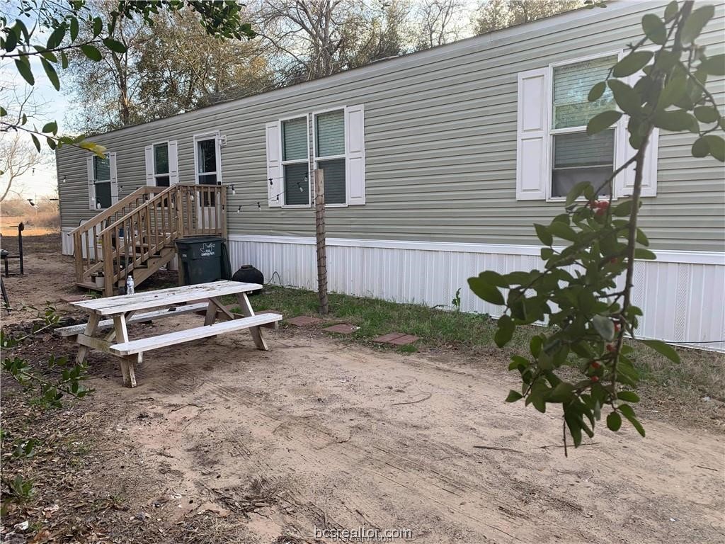 a white bench sitting in front of a house
